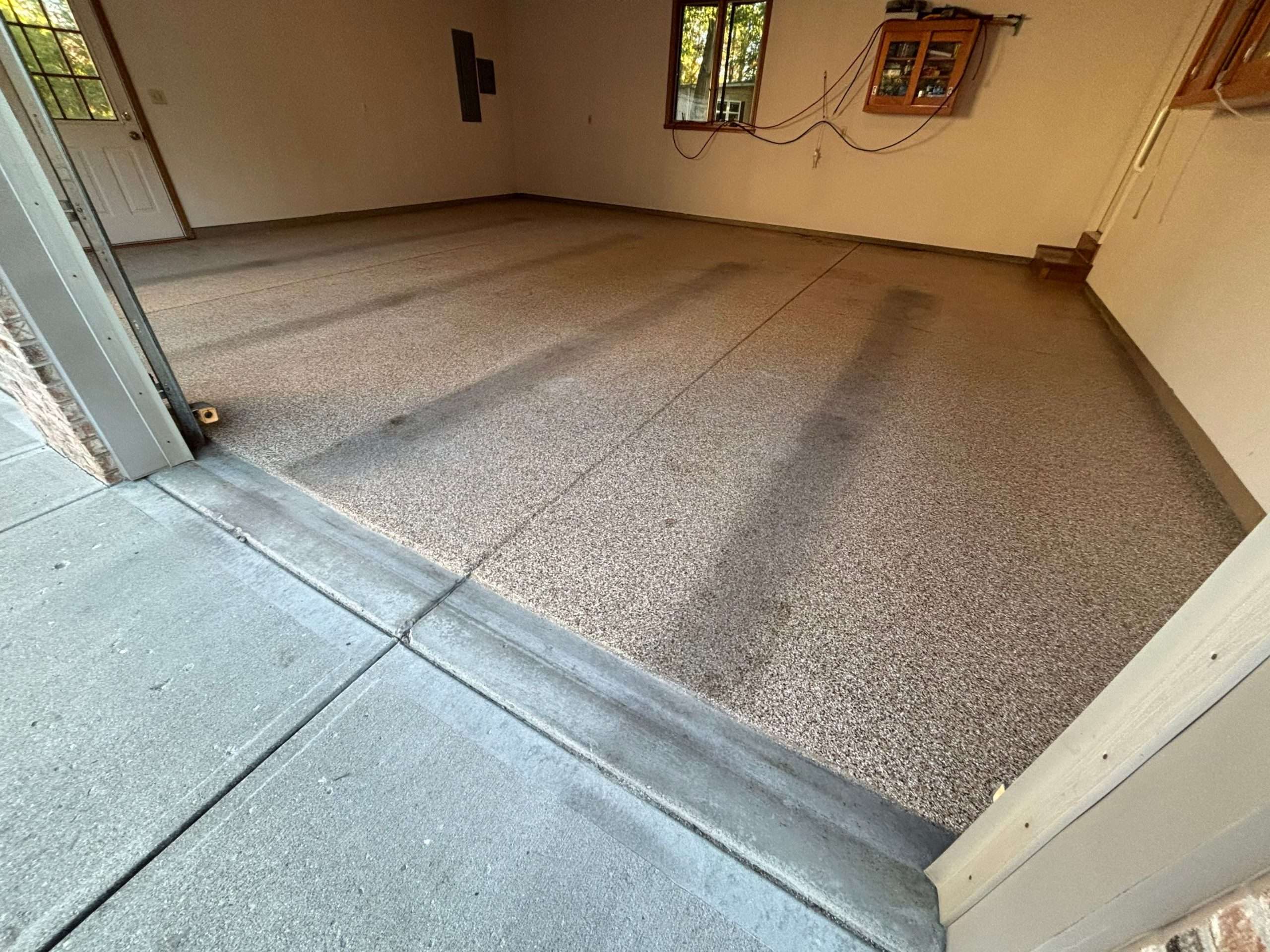 garage floor that had epoxy coating on it